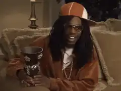 Snoop Dogg holding a cup saying Yeah
