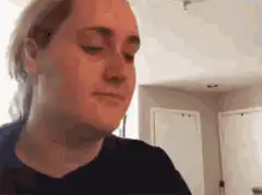 Woman drinks and makes disgusted face