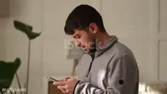 Guy checking phone shocked by clickbait