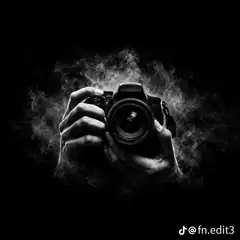 hands holding camera in smoke