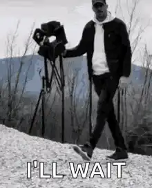 man sits in director chair i'll wait