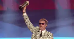 Colin Farrell as Austin Powers holding trophy