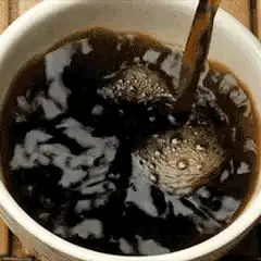 Pouring coffee into a cup