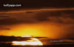 Sun rising through clouds