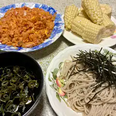 Japanese meal with kimchi fried rice, soba, corn, and seaweed