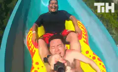 Two men on a water slide selfie