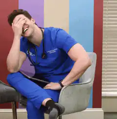 Doctor facepalming while laughing