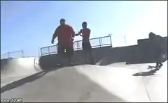 Skateboarder falls on ramp