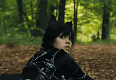 Wednesday Addams crawling in forest