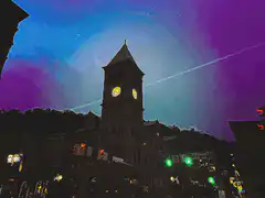 clock tower with glowing yellow faces