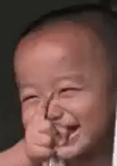 Baby laughing with hand over mouth