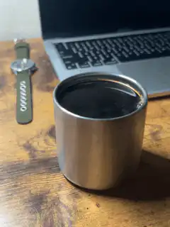 Coffee cup on desk with laptop