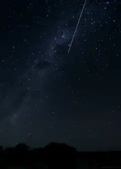 shooting star over milky way