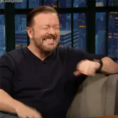 Ricky Gervais laughing hysterically