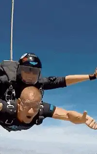 Tandem skydiver gives thumbs up