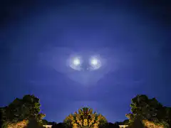 moon with eyes in the night sky