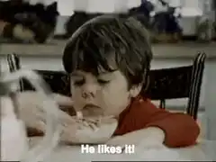 Boy eating cereal with mouth full