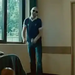 Bald man in sunglasses dancing
