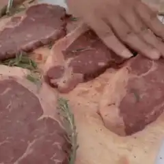 Man throws steak into fire