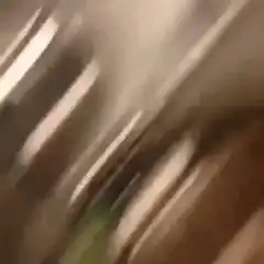 Man holding giant spoon in kitchen