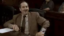 Man in suit gives thumbs up