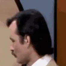 Man turns head and purses lips