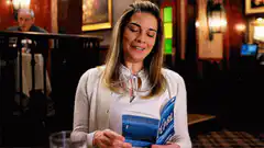 Woman reading Pearl book in restaurant