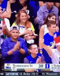 Woman holding baby at basketball game