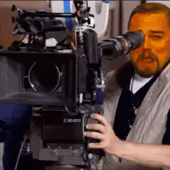 Leonardo DiCaprio looking through a movie camera