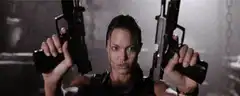 Angelina Jolie holding two guns