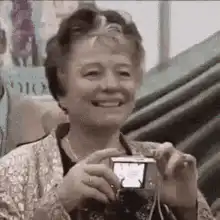 Old lady takes a photo with a digital camera