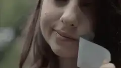Girl putting duct tape on her mouth