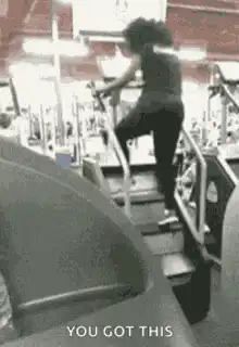 Woman running up stairs in gym