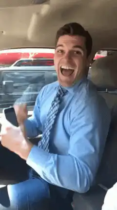 Man in car screaming excitedly