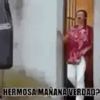 Man in pink shirt dancing next to punching bag