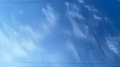 blue sky with wispy clouds and power lines