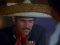 El Mariachi drinks and stares