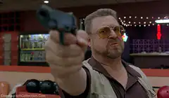 John Travolta pointing gun in Pulp Fiction