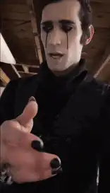 Goth man with black tears reaching out