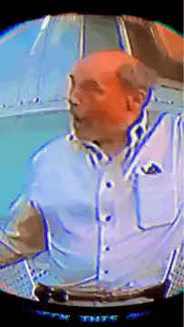 Man in white shirt looks up and raises arm