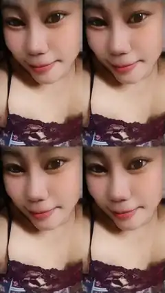 woman in purple lace top smiling