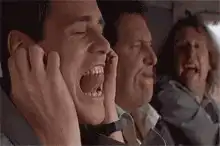 Man screaming with hands on ears