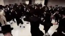 Crowd of people in black suits dancing
