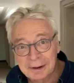Old man with glasses looking surprised