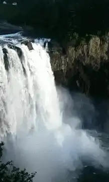 Powerful waterfall crashing into mist