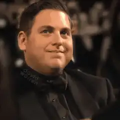 Jonah Hill smirking and giving a thumbs up