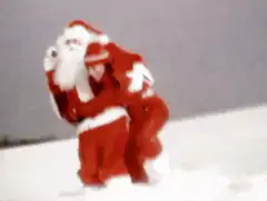 Santa and elf fall in snow