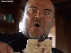 Man eating cake with intense expression