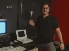 Man smashing computer with hammer