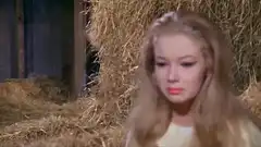 Little devil scares crying woman in hay